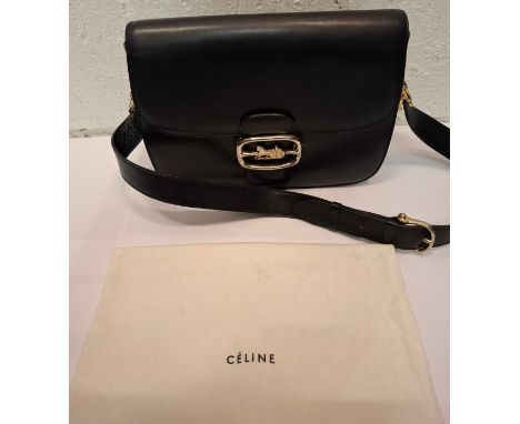 Celine-A vintage navy leather shoulder bag having gold tone hardware, a horse and carriage latch fastening, 3 internal compar
