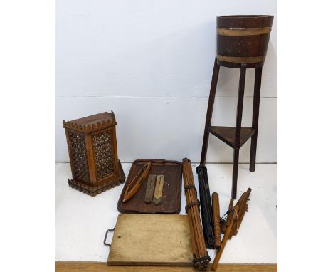 A collection of timber based items to include a Liberty style fretwork wall hanging bracket, two tripods, a turned truncheon 