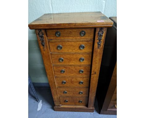 A Victorian mahogany Wellington chest of seven graduated drawers having later brass ring handles and mounts on plinth base 10