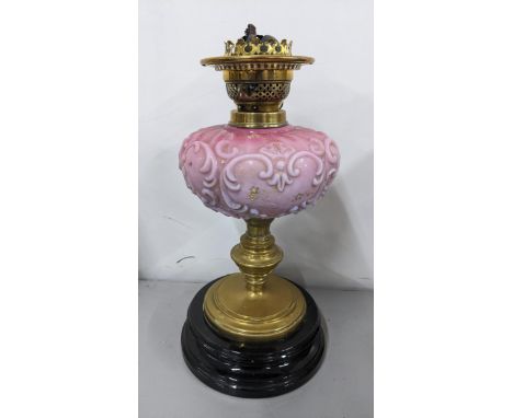 A Victorian brass oil lamp having a pink moulded glass reservoir and on a lacquered base, 37cm h Location: 11.1If there is no