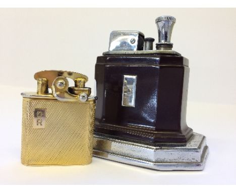 An Art Deco Ronson Bakelite and chrome cased table top lighter together with a gold plate engine turned lighter.