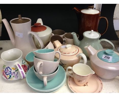 A collection of various Poole Pottery tea ware items including teapots and Twin Tone designs.