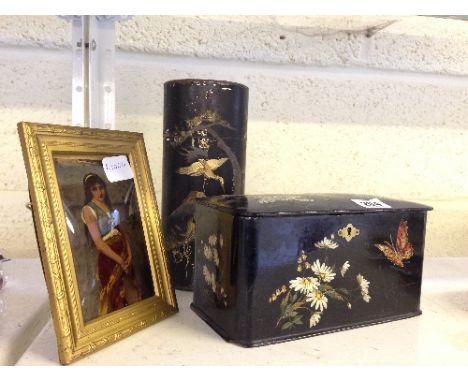 A black lacquer box with painted flower and butterfly decoration together with an Oriental lacquer tubular box and a gilt fra