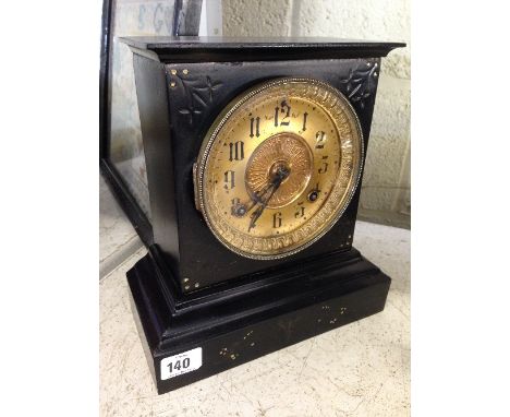 A late 19th century black painted metal cased American mantle clock with gilt brass dial.