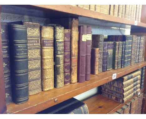 A shelf containing thirty one 19th century and other small leather bound volumes and books (mainly French).