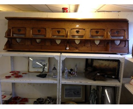 A pine church pew back converted for use as a wall shelf.