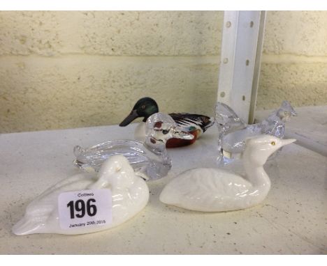 Two Poole Pottery bone china white glazed bird models together with three others.