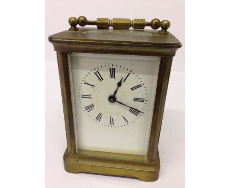 A brass and glass cased carriage clock (hairline to dial).