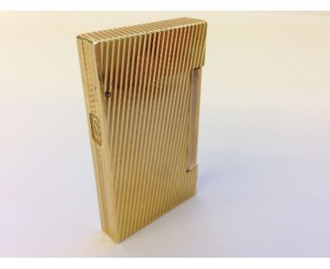 A Dupont gold plated cigarette lighter.