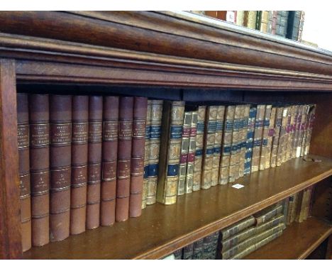 A shelf containing various sets of 19th century French leather bound volumes and books including Memoires Historiques Littera