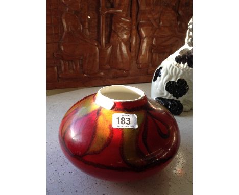 A Poole Pottery Delphis vase, shape 32, decorated in an abstract pattern on red ground.