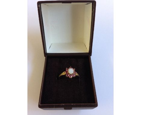 A 9 carat gold ladies' garnet and opal dress ring.