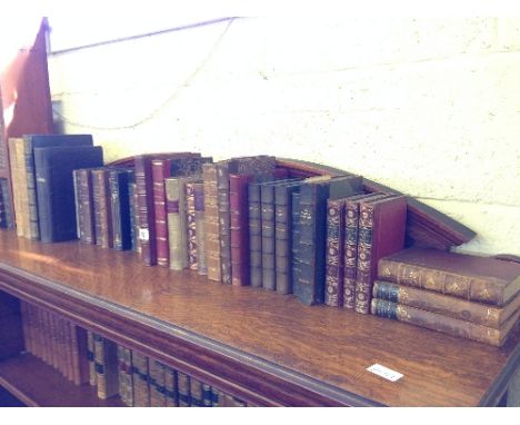 A shelf containing thirty four various French leather bound 19th century and other volumes and books.