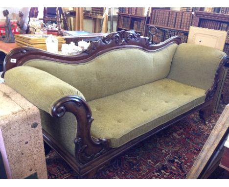 A large 19th century mahogany framed Empire style sofa in green upholstery.