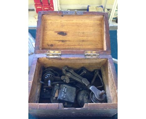 A small pine box containing various tools.