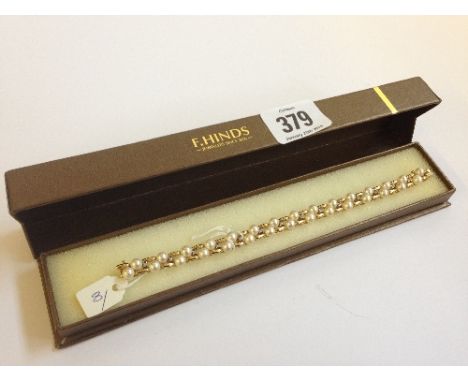 A 14 carat gold diamond and cultured seed pearl set bracelet (21g overall).
(Ref 8)