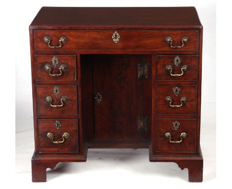 AN EARLY GEORGE III MAHOGANY KNEEHOLE DESK the caddy moulded top above a full-length single drawer and three graduated side d