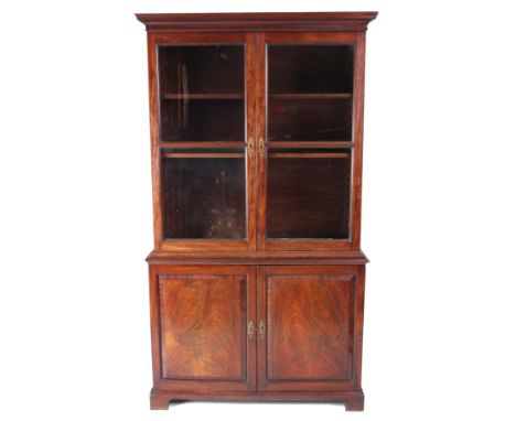 A GEORGE II FLAMED MAHOGANY GLAZED BOOKCASE OF SMALL SIZE having glazed sectional&nbsp;top above a cupboard base with fielded