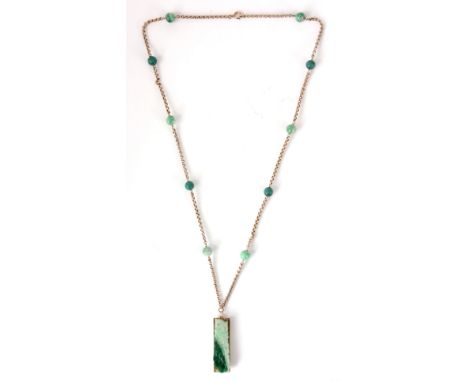 A GOLD AND JADE NECKLACE AND PENDANT the sectional chain linked together by jade balls with a gold and carved leaf-work jade 