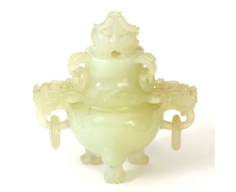 A LIGHT GREEN CHINESE JADE INCENSE BURNER finely carved with dragon head side handles and lid; standing on paw feet 9.5cm wid