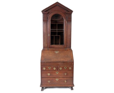 AN UNUSUAL SMALL EARLY 18TH CENTURY OAK BUREAU BOOKCASE with architectural shaped top section having a rounded glazed top doo