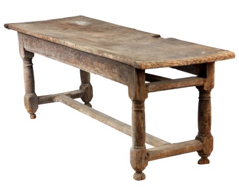 A LATE 17TH CENTURY OAK ENGLISH REFECTORY TABLE having one piece top with cleated ends, above a pegged base with ring turned 