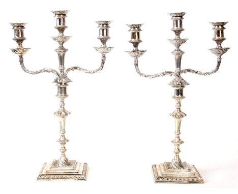 A LARGE PAIR OF LATE 19th CENTURY SILVER THREE LIGHT CANDELABRA of Georgian style, the square bases with swirl centres and ga