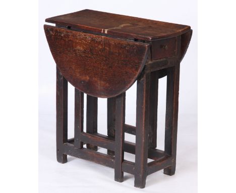 AN EARLY 18TH CENTURY SMALL GATE LEG SIDE TABLE with square joined legs with end drawer and a drop leaf oval top 68cm wide 34