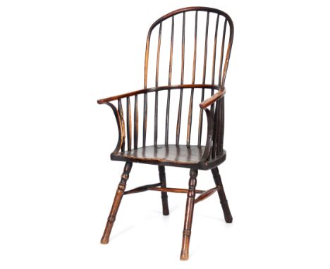 AN EARLY 19TH CENTURY ASH AND ELM COMB BACK WINDSOR ARMCHAIR with hooped back and bent wood arm supports, shaped seat and sta