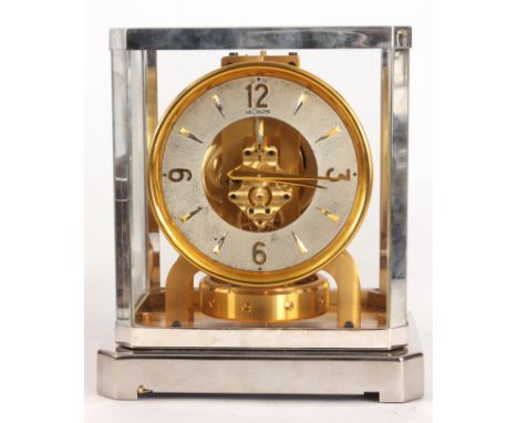 A 1950's RHODIUM PLATED AND GILT LECOULTRE ATMOS CLOCK the removable cover having five glass panels set in canted cornered fr
