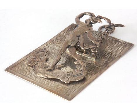 A LATE 19TH CENTURY SILVER HANGING/ DESK PAPERCLIP formed as an Arc Angel amongst clouds, mounted on an engine turned back, w