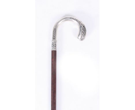 AN EARLY 20th CENTURY SILVER HANDLED WALKING CANE with relief work decoration on a tigerwood stick 90cm overall&nbsp;