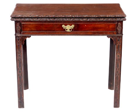 A GEORGE III CHIPPENDALE DESIGN MAHOGANY CARD TABLE with floral carved edge hinged top revealing a baize interior with guinea