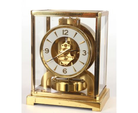 A JAEGER-LECOULTRE ATMOS CLOCK with gilt brass framed case with hinged front door enclosing a skeletonised chapter ring with 