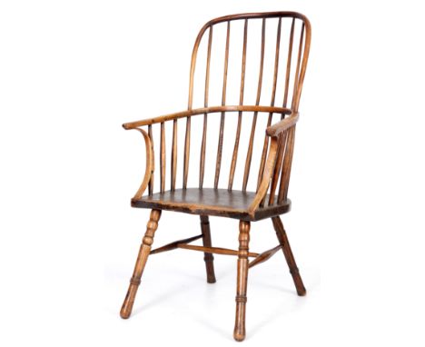 AN EARLY 19TH CENTURY ASH AND ELM COMB BACK WINDSOR ARMCHAIR with hooped back and bent wood arm supports, shaped seat and sta