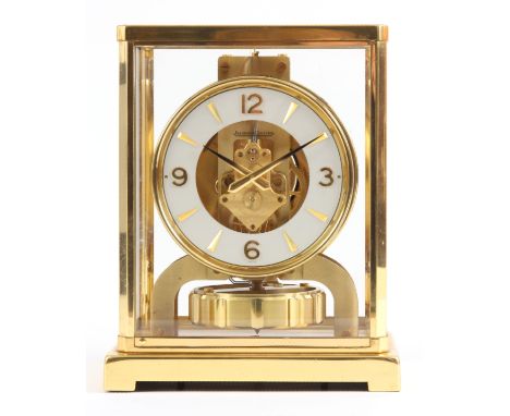 A JAEGER-LECOULTRE ATMOS CLOCK with gilt brass framed case with hinged front door enclosing a skeletonised chapter ring with 