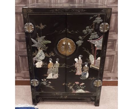 20TH CENTURY CHINESE EBONISED SIDE CABINET, wtih gilt decoration allover, the pair of doors decorated in relief with applied 