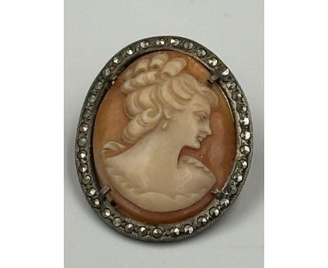 A vintage cameo on silver brooch with lady in classical in pose.