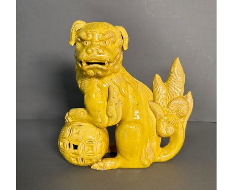 A yellow ceramic temple dog H 24cm 