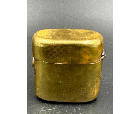 A brass traveling inkwell.