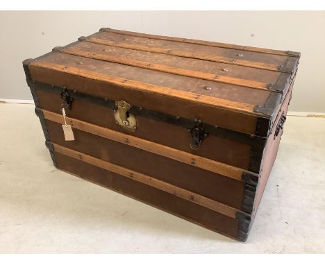 An early 20th century studded canvas covered travelling trunk, width 92cm, depth 50cm, height 53cm