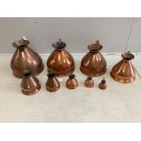 A matched graduated set of nine late 19th / early 20th century copper haystack measures, four
