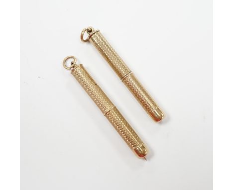 Two engine turned 9ct gold cased propelling toothpicks, 43mm.