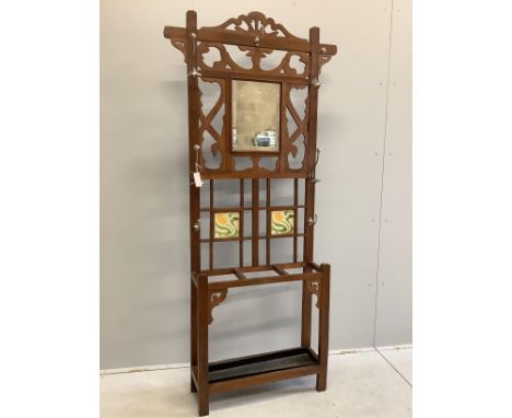 A late Victorian oak mirrored and tile back hallstand, width 94cm, height 200cm