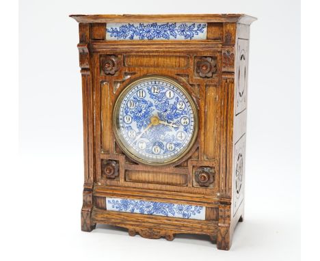 A Victorian carved oak aesthetic mantel clock, 24cm high Ceramic dial and the two ceramic insets good; clock-hands discoloure