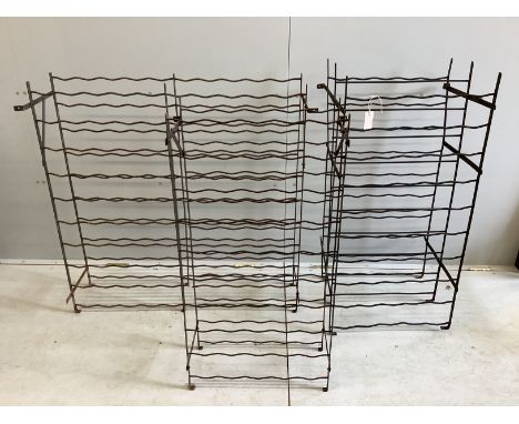 Three vintage wrought iron wine racks, largest height 106cm