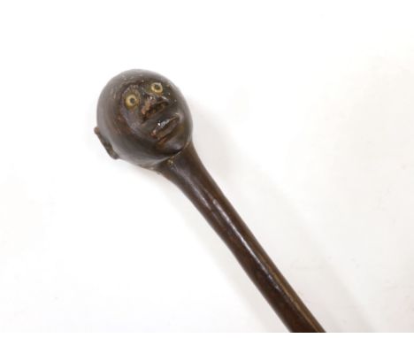 An African carved ebony walking stick, Gogo tribe, Tanzania, with inset eyes, 128cm (damage to foot)