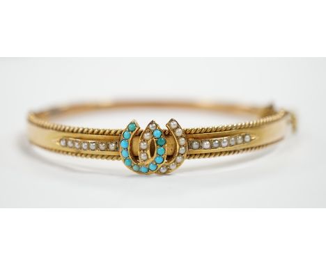 A 9ct gold, seed pearl and turquoise set twin horseshoe motif hinged bangle, gross weight 7.5 grams.