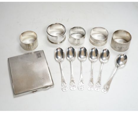A concave engine turned cigarette case, 10.3cm, five assorted silver napkin rings and a set of six silver coffee spoons, 12.9
