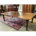 A late Victorian Aesthetic period oak extending dining table, 258cm extended, two spare leaves,